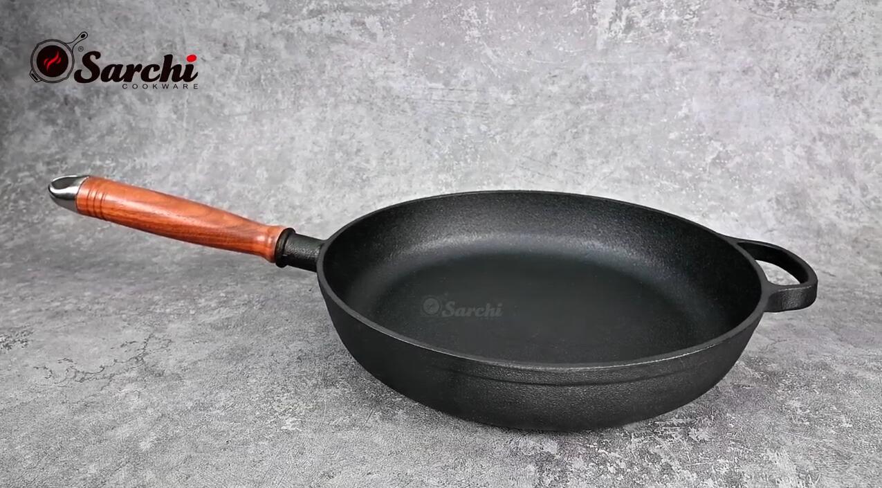 cast iron frying pan with long wooden handle