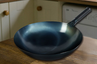 Which carbon steel woks are popular in Europe and America?